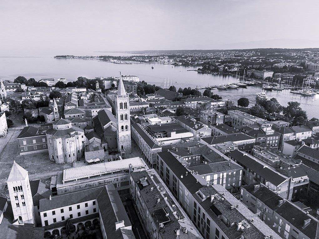 A bird view photo of Zadar peninsula, with the Church of St. Donatus, The Cathedral and Bell Tower
