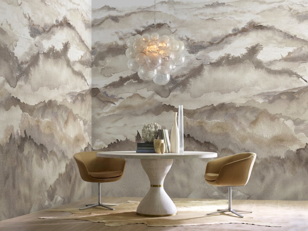 Modern dining room featuring mountain landscape wallpaper, bubble chandelier, and pedestal table.