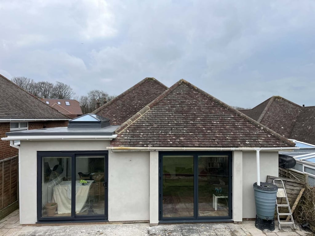 Completed bungalow rear extension with large sliding doors and modern exterior finish.