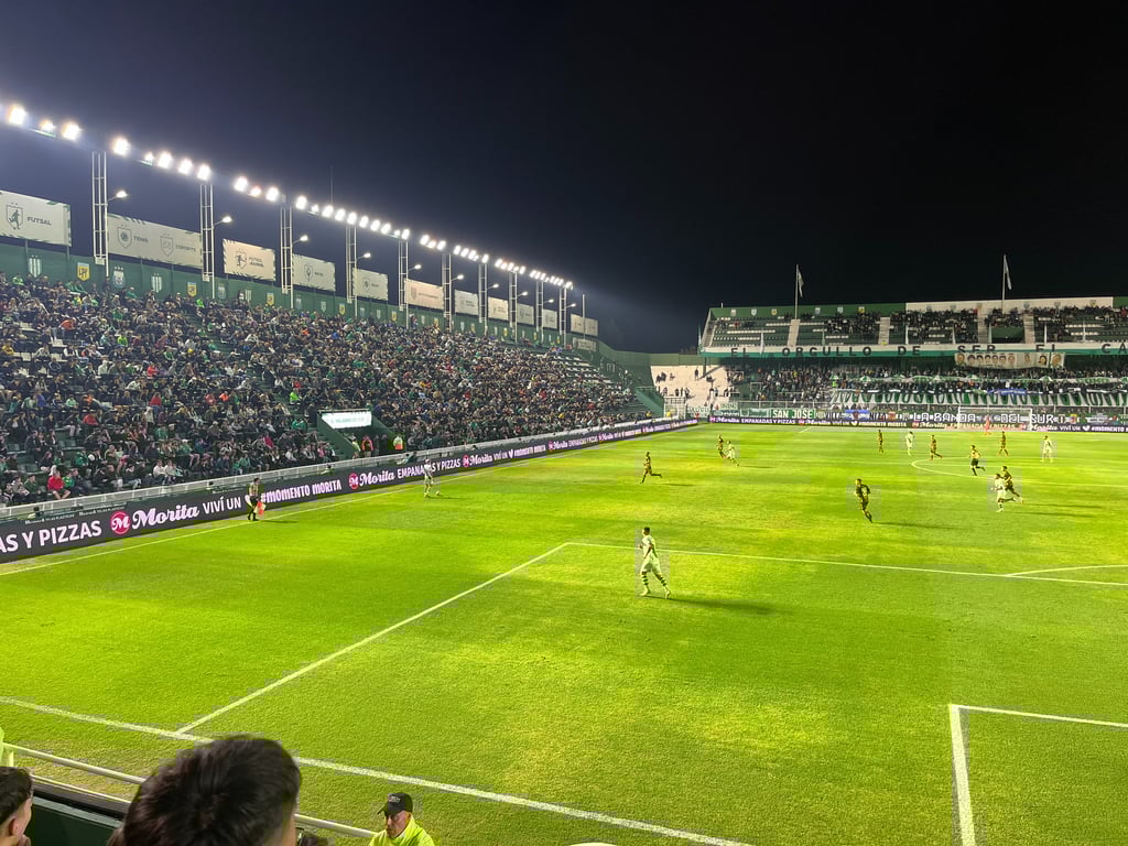 Estádio Florencio Sola durante jogo entre Banfield e Platense, com torcedores nas arquibancadas e clima de partida oficial.