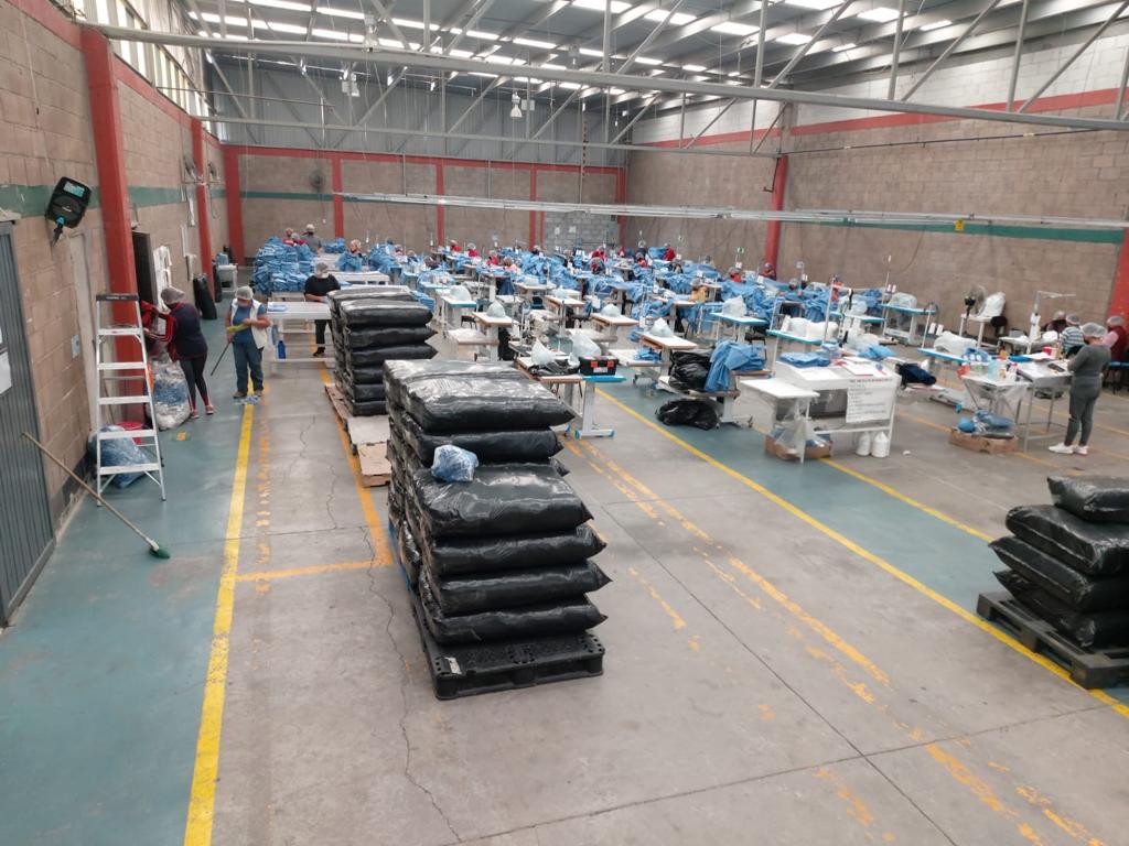 a large room with many emplyees making uniforms