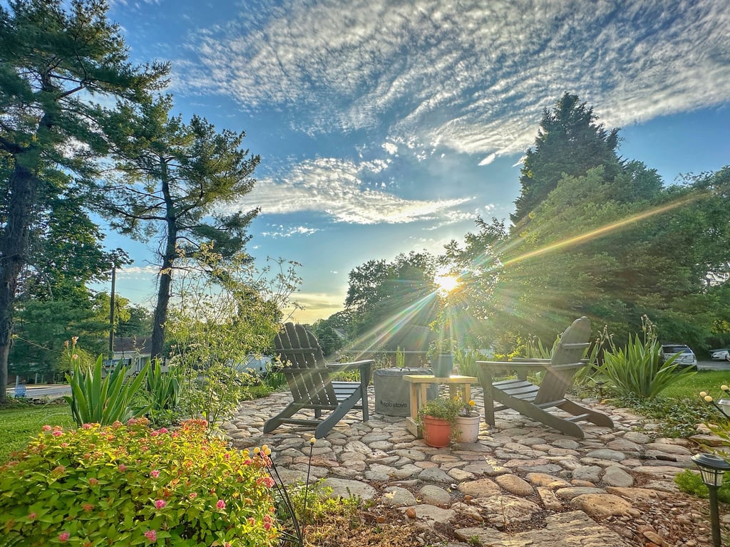 a patio with chairs and a fire pit