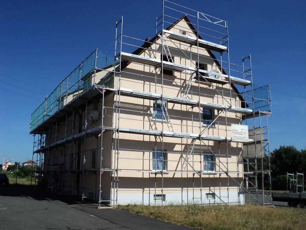 a house with scaffiered scaffolding on the side of a building