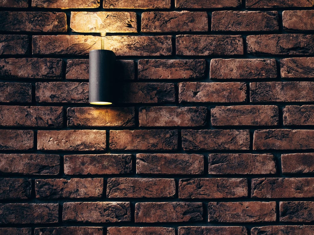 a brick wall with a light installed by pbp services in worcester 