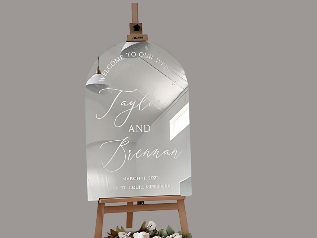 clear wedding sign for taylor and bremman with wooden stand