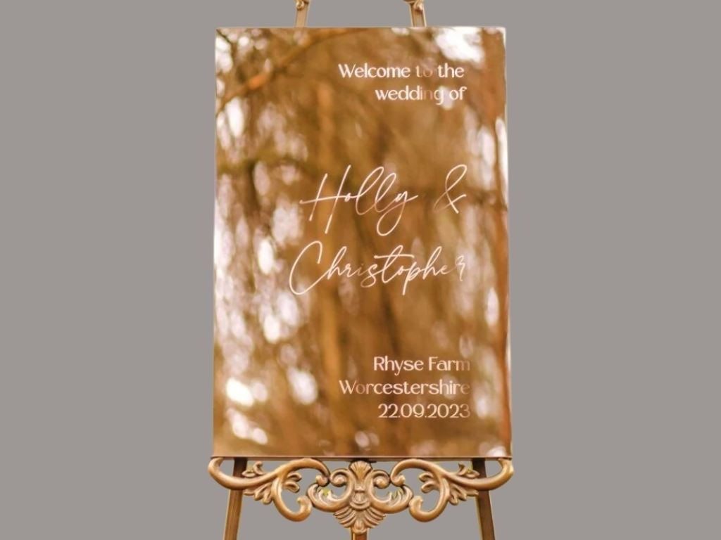gold mirror sign for holly and christopher