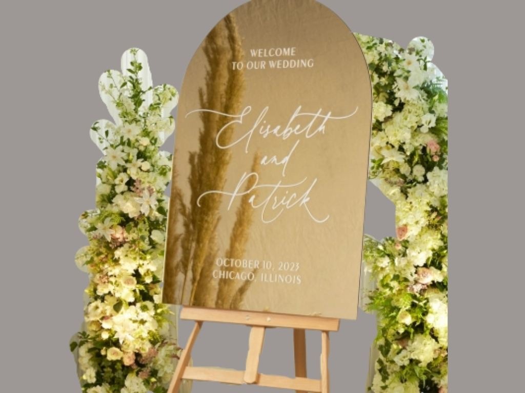 gold arch mirror sign of elisebeth and patrick
