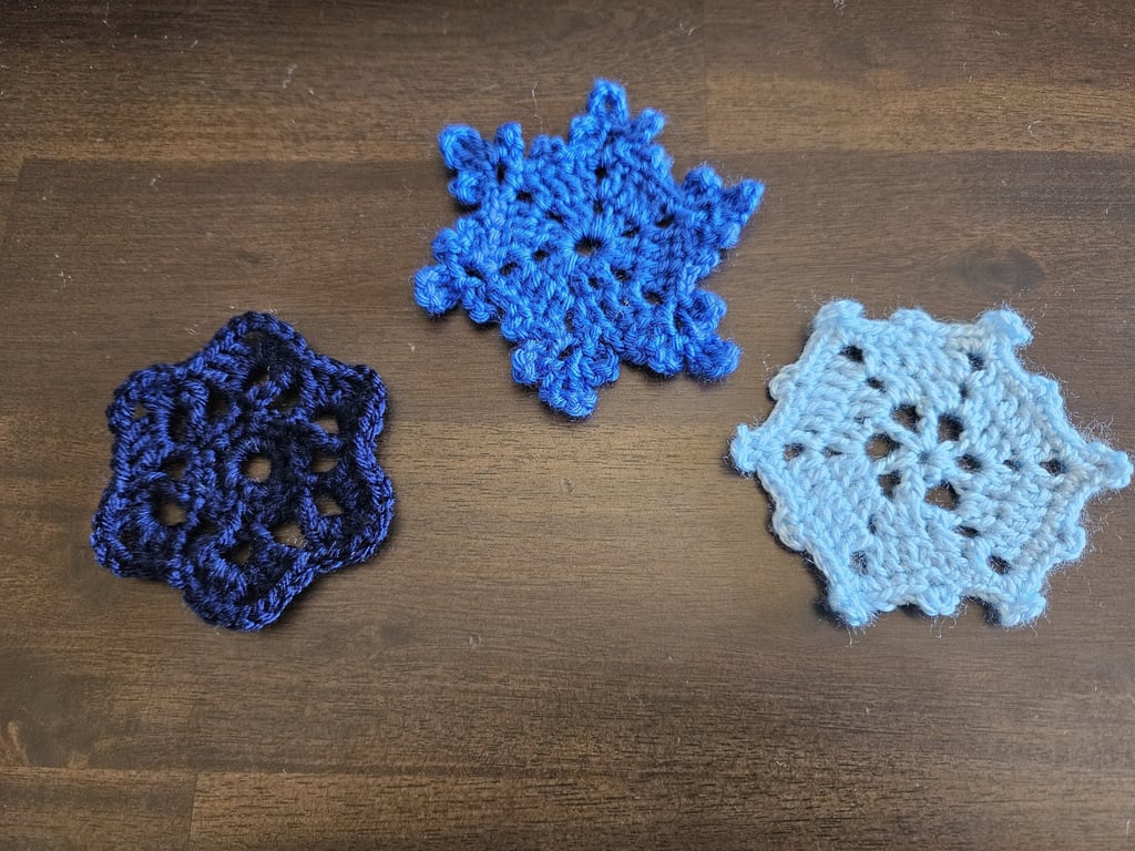 blue crochet snowflakes on a wooden background