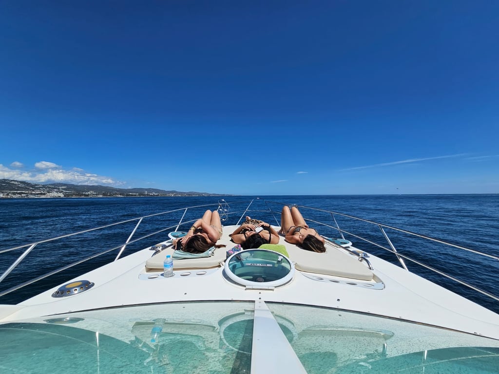 two people laying on a boat in the ocean