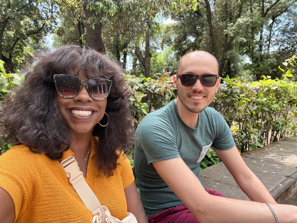 a man and woman sitting on a bench in a park