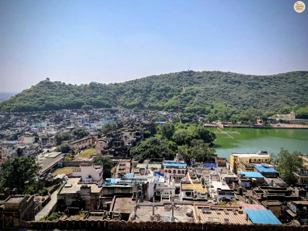 Panoramic view of Bundi town and Nawal Sagar Lake from Garh Palace, capturing the blue houses, serene waters, and royal charm