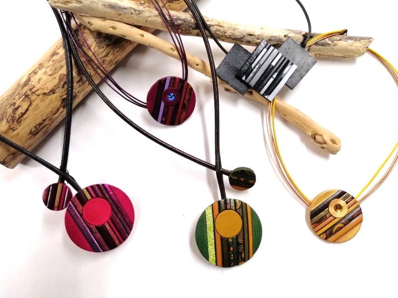 a bunch of necklaces with different colored circles