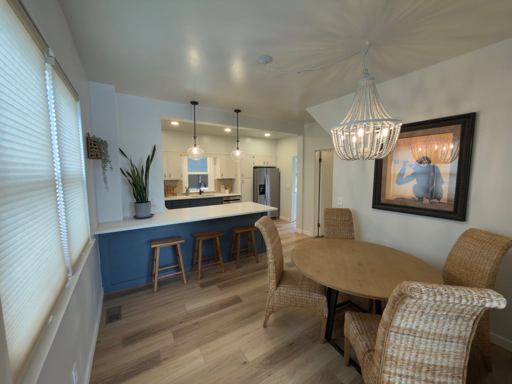 Staged Modern open concept kitchen and dining room featuring a blue breakfast bar in Ohio.