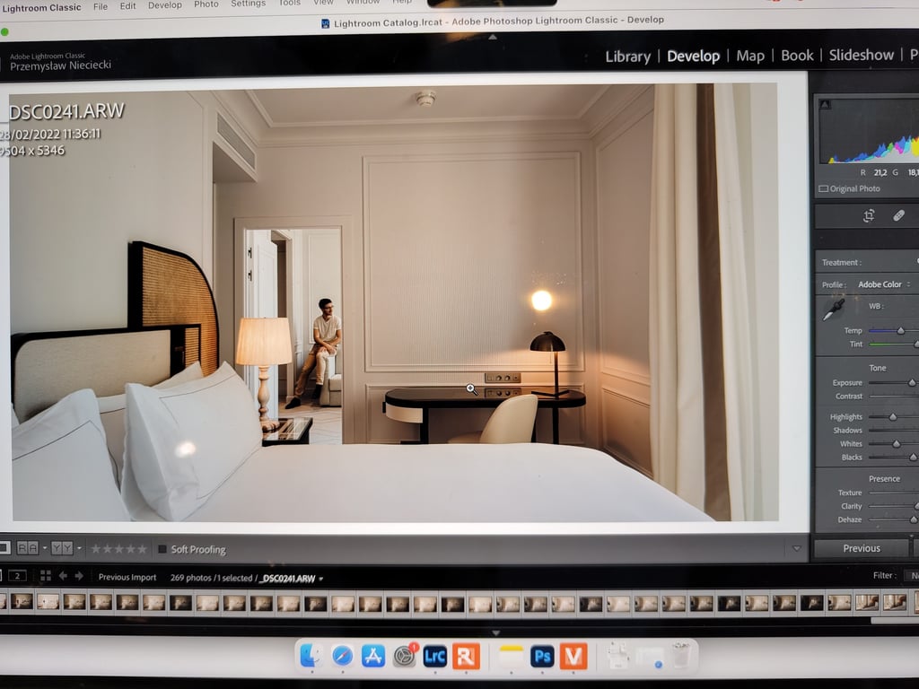 A suite at Regent Carlton Cannes with a bed in the foreground and Rémi Lefèvre in the background