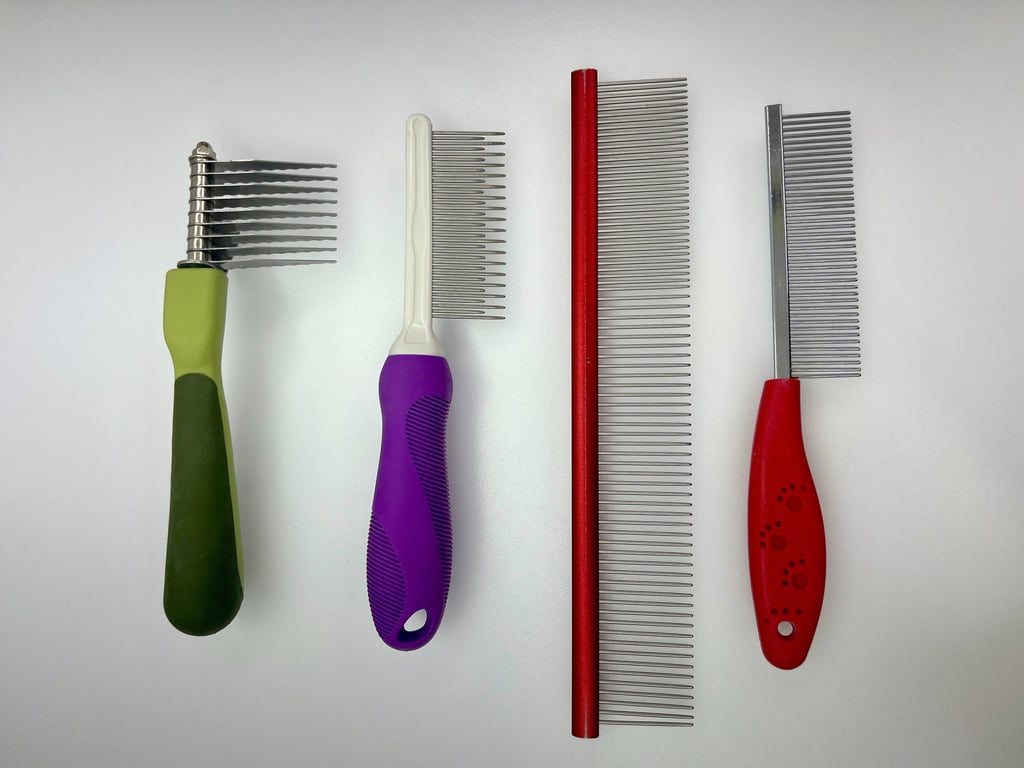 Professional dog grooming combs and dematting tools used for coat care, detangling, and finishing