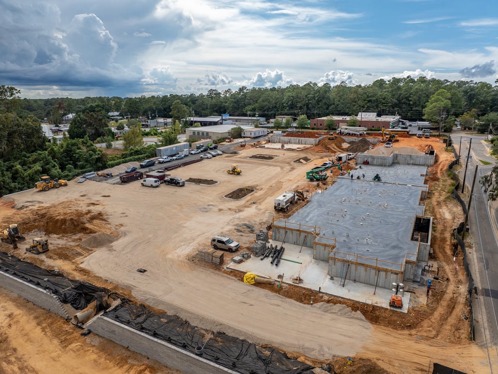 a large building with a lot of construction equipment