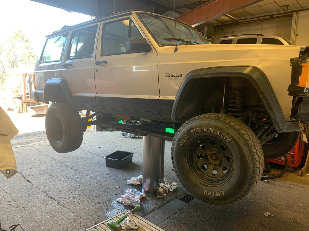 Suv on a lift in the middle of an oil change