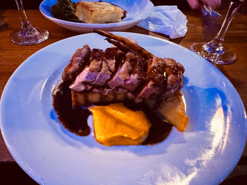 a plate of food and a glass of wine