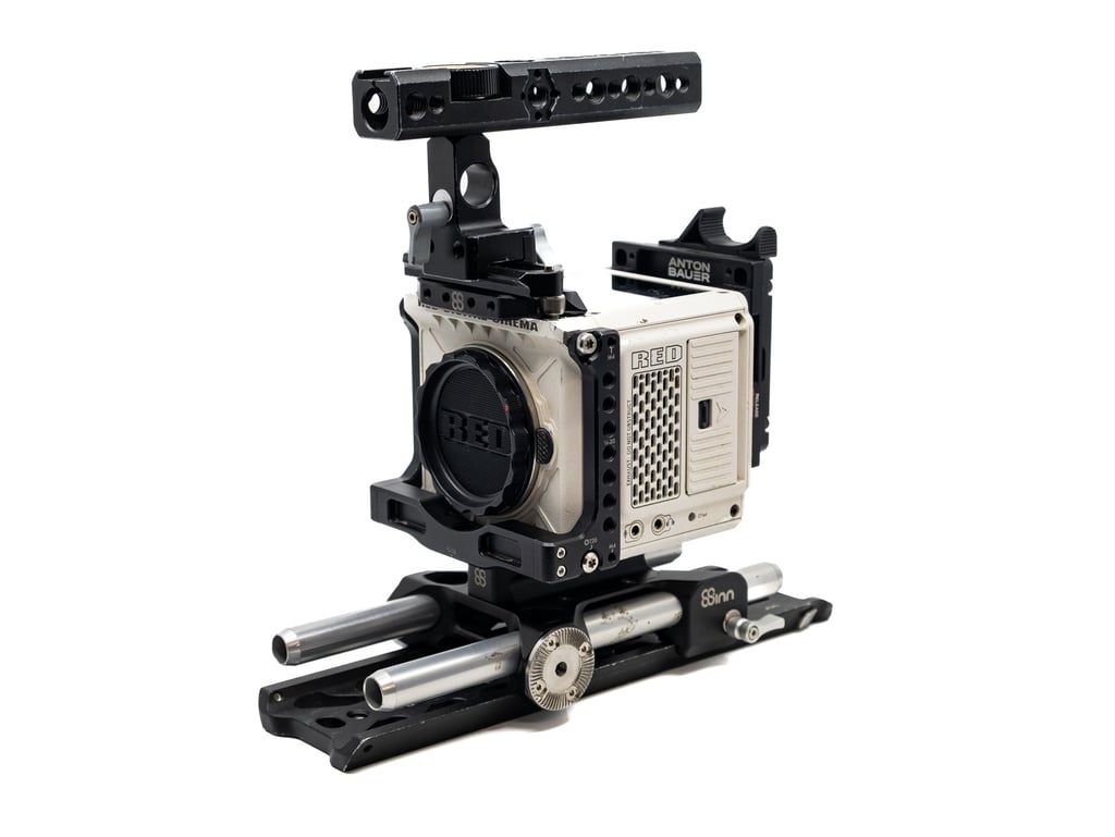 Close-up of a RED camera mounted on a rig with adjustable support rods, ideal for professional filmmaking.