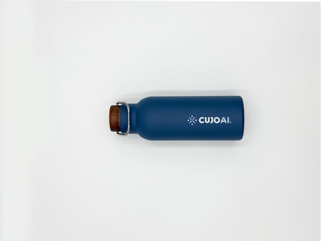 A blue CUJO AI branded insulated stainless steel water bottle with a wooden cork cap on a white background.