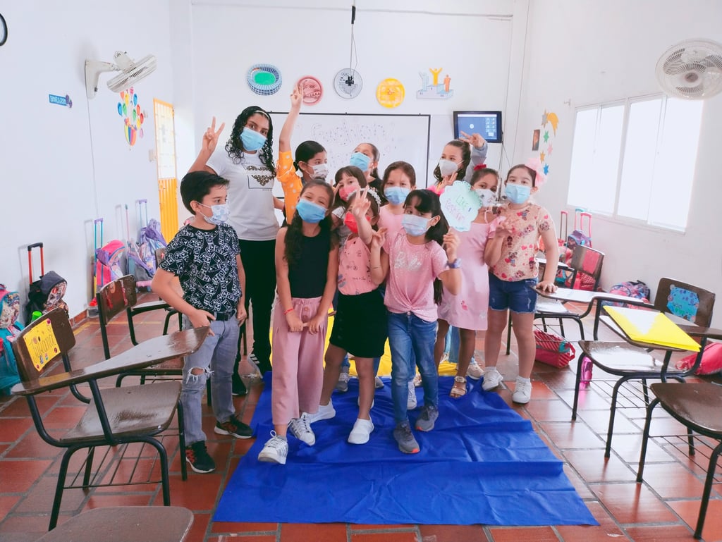 a group of children and the teacher in a classroom