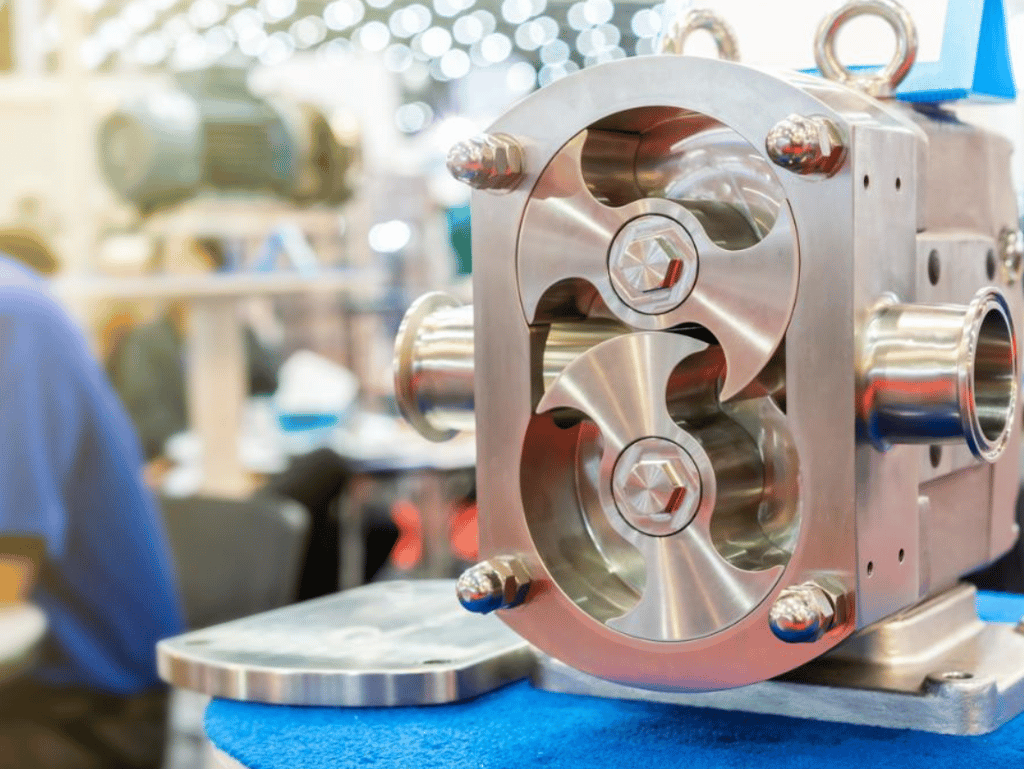 Industrial stainless steel rotary lobe pump for food and chemical fluid processing.