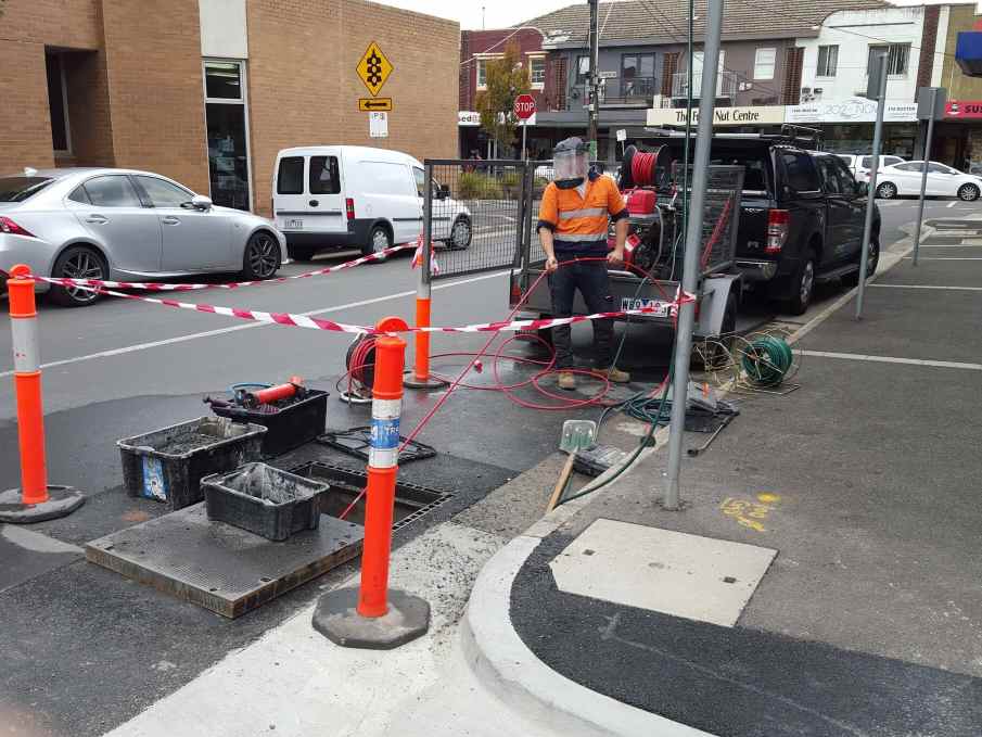 plumber unblocking stormwater pipes