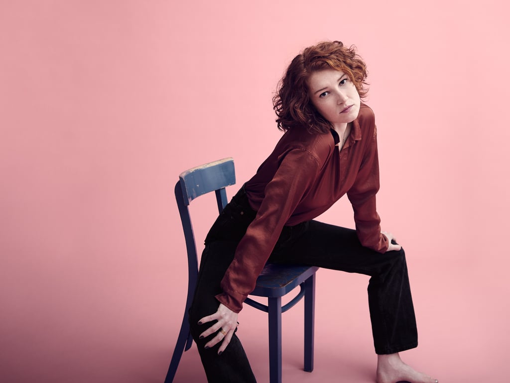 Woman stretching in a blue chair.