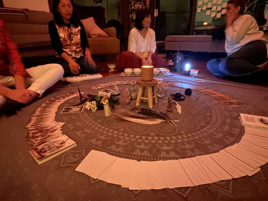 Women gathering in a spiritual circle around an altar at a monthly full moon event in Sydney, NSW