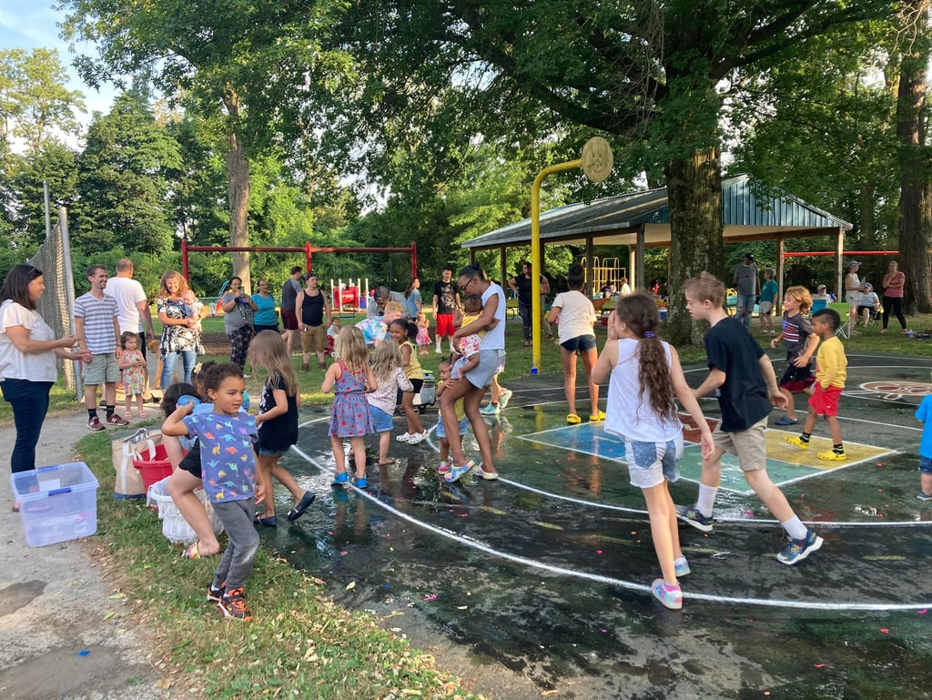 Children in a water balloon fight at Crescent Hills Park