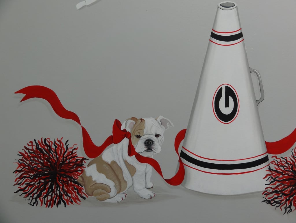 English Bulldog puppy mascot art with a red bow, cheerleader pom-poms, and megaphone.