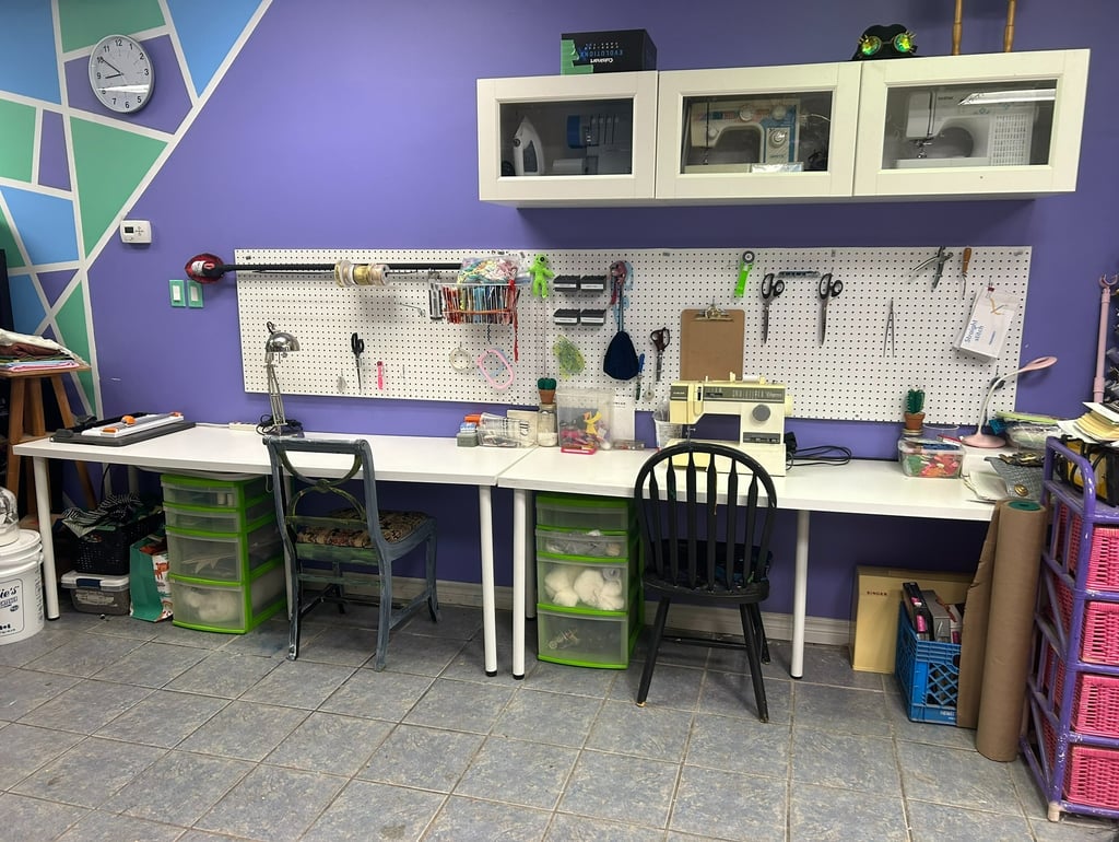 two desks with chairs, and a selection of sewing supplies and notions