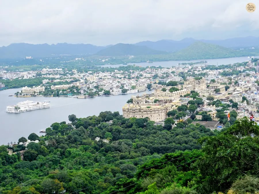 Panoramic hilltop view of Lake Pichola, City Palace, and Fateh Sagar Lake as seen from Karni Mata Temple in Udaipur.