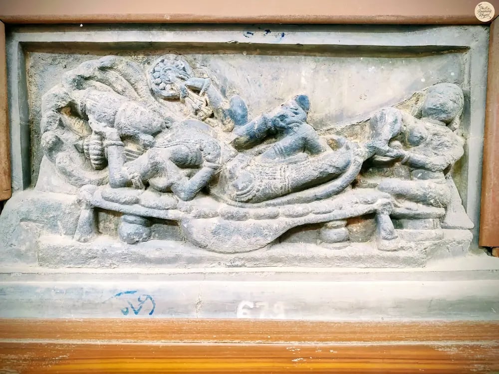 Intricate sculpture of Lord Vishnu resting on serpent Sheshnaga, attended by Goddess Lakshmi. 