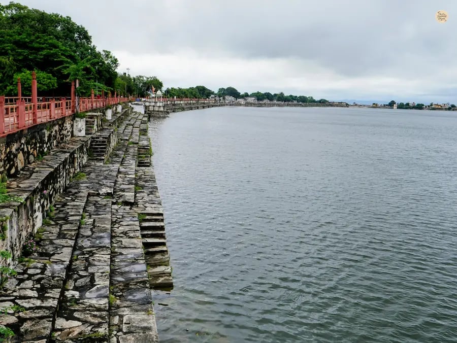 Rajsamand Lake shimmering in soft morning light with calm reflections and peaceful surroundings.