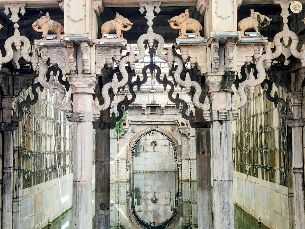 Ornate arches reflecting in the still waters of Rani Ji Ki Baori, Bundi — a mesmerizing play of stone and silence.