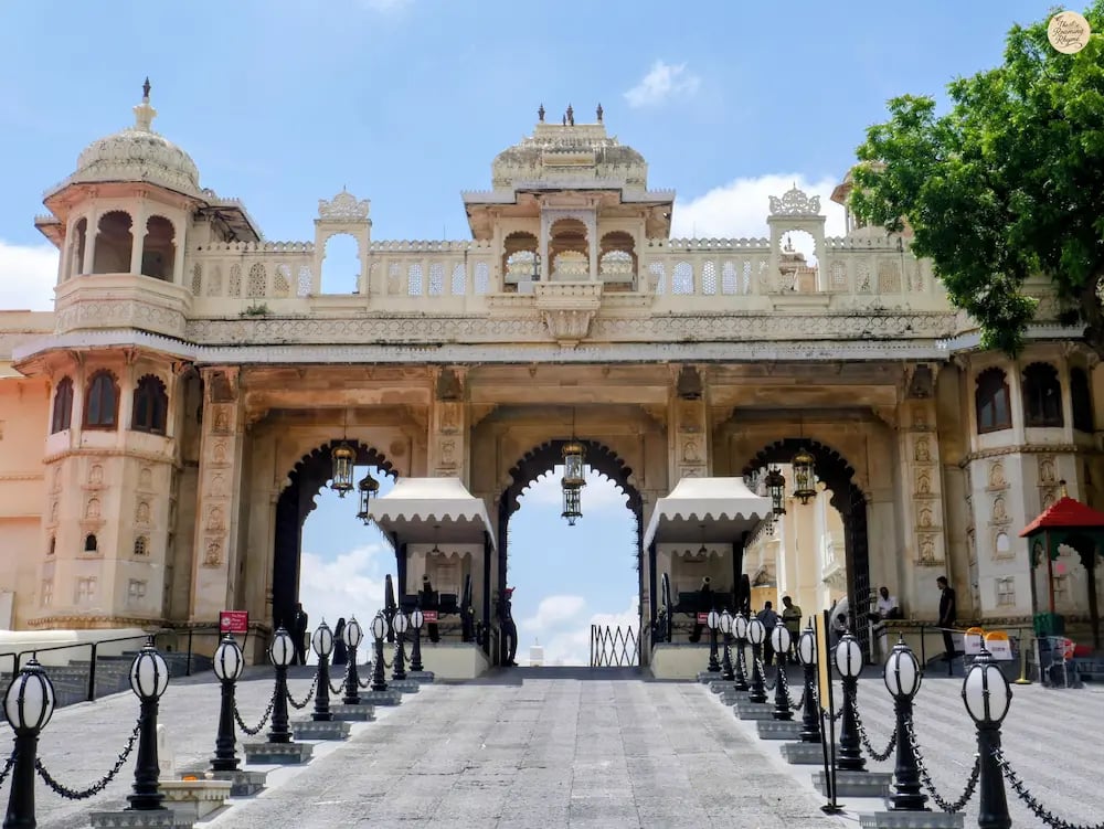 Tripolia entrance gate of Udaipur City Palace with three arched doorways and traditional Mewar architecture.