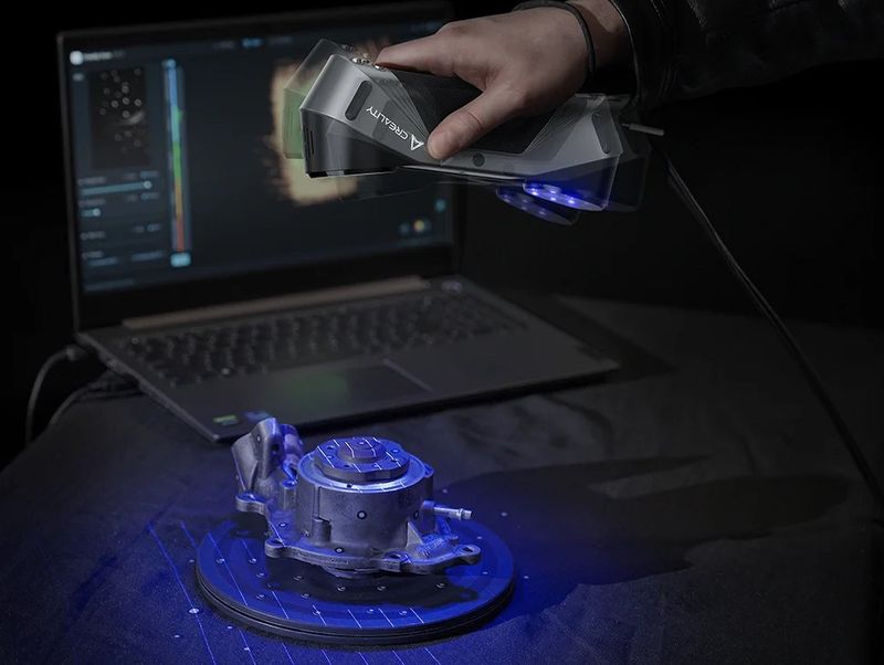 car part being 3d scanned with a blue laser
