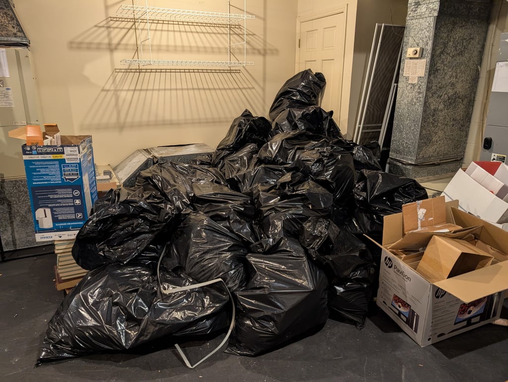 pile of trash bags and cardboard boxes