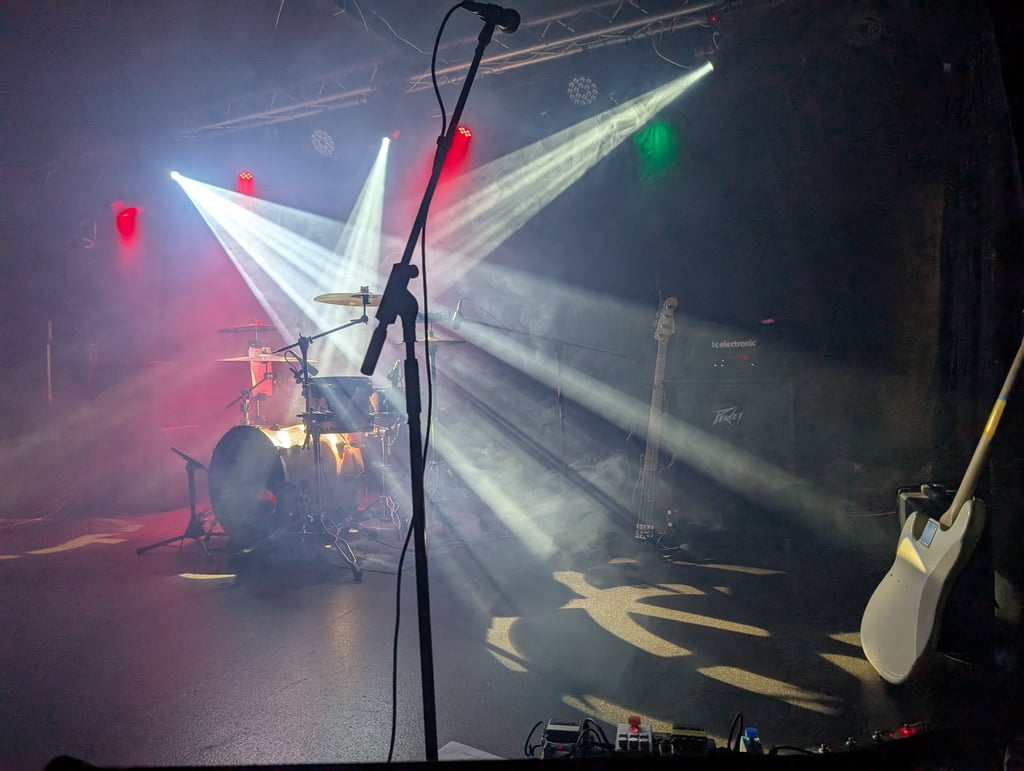 Professional stage lighting and PA setup for a Mosaic live performance at a marquee wedding