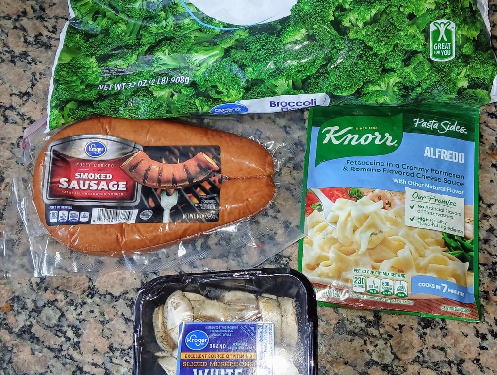 Ingredients for mushroom sausage alfredo pasta – includes mushrooms, pasta, cream, and sausage