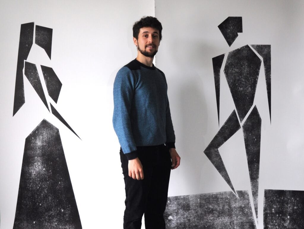 Jacob Chandler with his prints of Phoebe and Sylvius from As You Like It