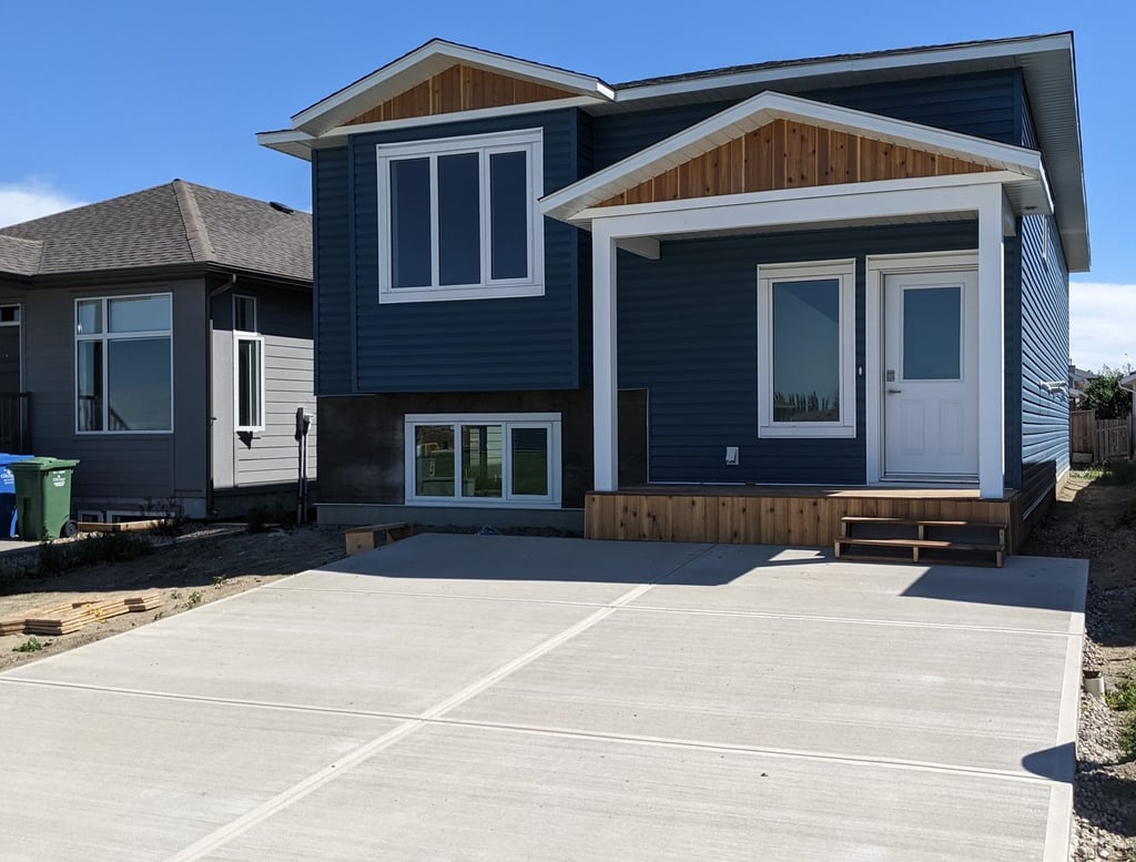 blue siding home with cedar and stone accents