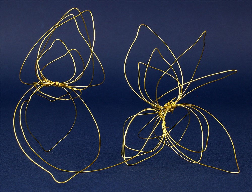 Abstract metal wire sculpture evoking two flowers