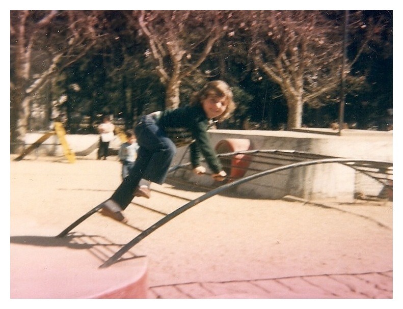 a young boy on a playground with a slider