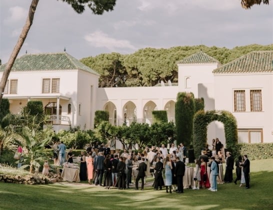 Garden event at Villa El Rincon with guests gathered among lush greenery