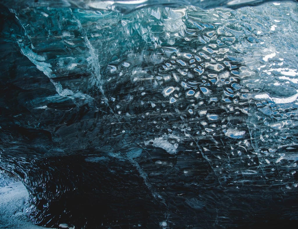 a close up of a large iceberg with water droplets