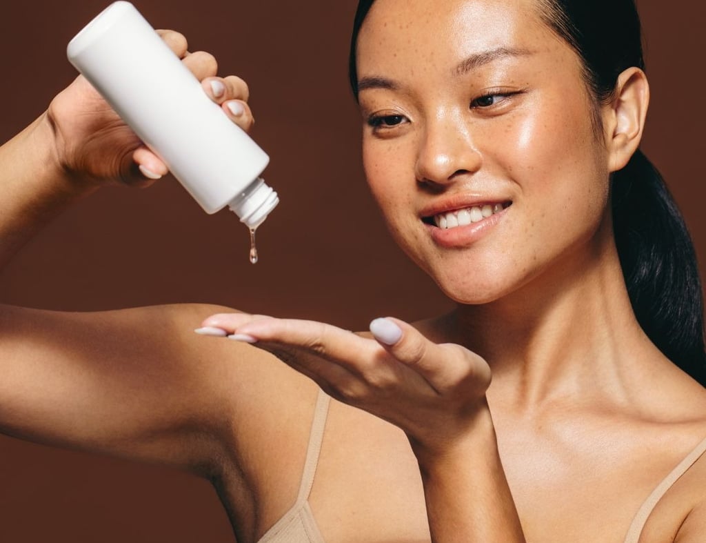 a woman holding a bottle of liquid in her hand