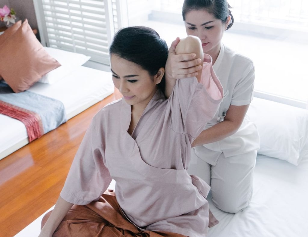 a woman in a robe is sitting on a bed