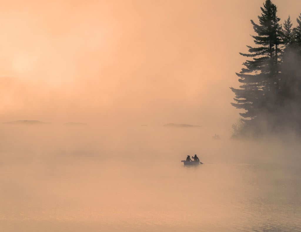 a couple of people in a boat on a lake